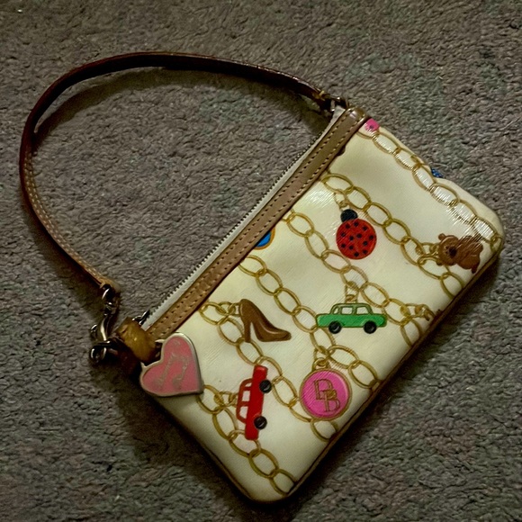 Dooney & Bourke Handbags - Authentic Signature Dooney & Bourke large slim wristlet with charm